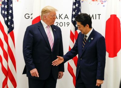 US President Donald Trump and Japanese Prime Minister Shinzo Abe shake hands at the start the G20 Summit in Osaka 28 June 2019 (Photo: Kimimasa Mayama/Reuters).