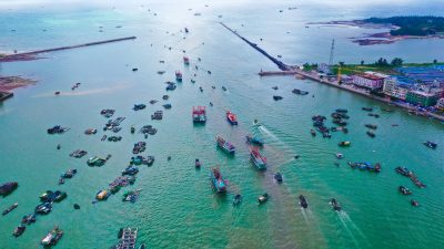 Fishing boats leave a port to resume fishing after three month fishing ban in Fangchenggang city, south China