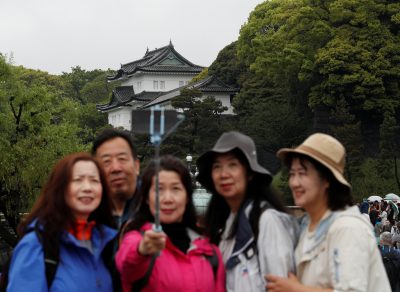 Chinese tourists take photos in front of the Imperial Palace in Tokyo, Japan, 30 April, 2019 (Photo: Reuters/Kim).