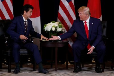 US President Donald Trump reaches out to shake hands with Japan