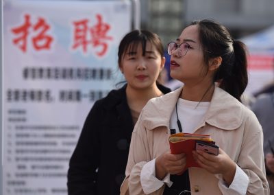 A Chinese job seeker looks for employment at a job fair at the Fuyang Normal University in Fuyang city, east China