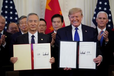 US President Donald Trump stands Chinese Vice Premier Liu He after signing