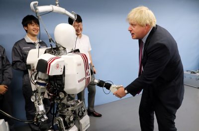 Boris Johnson shakes hands with a humanoid robot Wabian2 at Research Institute for Science and Engineering at Waseda University