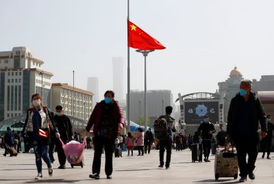 The Chinese national flag flies at half-mast near of Beijing Railway station as China holds a national mourning for those who died of the coronavirus disease (COVID-19), 4 April 2020 (Photo: REUTERS/Thomas Peter).