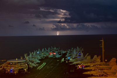 Lightning flashes over the aircraft carrier USS Nimitz (CVN 68) as it transits the South China Sea, 4 July, 2020. (Reuters/John Philip Wagner, Jr.).