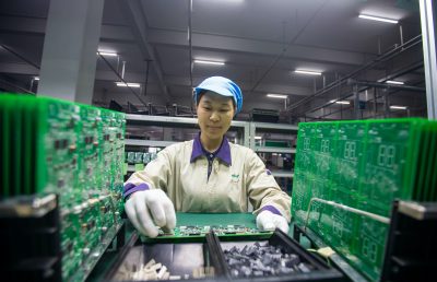 A worker inspects and arranges production for elevator signal system at a factory of Jiangsu WELM Technology Co., Ltd. in Hai'an city, east China's Jiangsu province, 24 August, 2020 (Photo: Reuters).