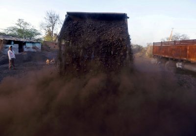 A worker watches as a loader unloads coal at a yard on the outskirts of Ahmedabad, India, 12 February 2016. India is asking the country's big steelmakers to consider converting local medium-quality coal into premium coking coal to slash an annual import bill of more than $4 billion for buying that grade from countries such as Australia (Photo: Reuters/Amit Dave).