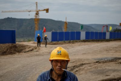 A worker stands outside a construction site of the Xinzhuang coal mine that is part of Huaneng Group's integrated coal power project near Qingyang, Ning County, Gansu province, China, 19 September 2020 (Photo: Reuters/Thomas Peter).
