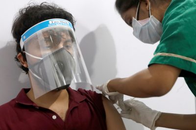 A man wearing a face shield receives a dose of COVISHIELD, a coronavirus disease (COVID-19) vaccine manufactured by Serum Institute of India, at a vaccination centre in Mumbai, India, 1 May 2021 (Photo: Reuters/Francis Mascarenhas).