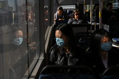Lan Zhang and Elma Song, international students from China, travel on a bus as they go shopping, Sydney, Australia, 3 July 2020 (Photo: Reuters/Loren Elliott)
