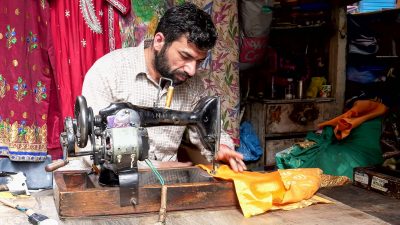 Dressmaker making a garment in his workshop, Amritsar, India, 18 March 2019 (Photo: Reuters/Christopher Bellette)