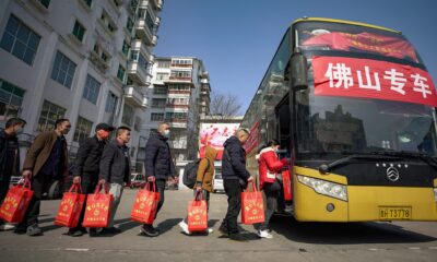 Migrant workers take a government-chartered bus to work elsewhere in Qiandongnan,Guizhou Province, China, 29 January 2023 (Photo by Reuters/CFOTO).