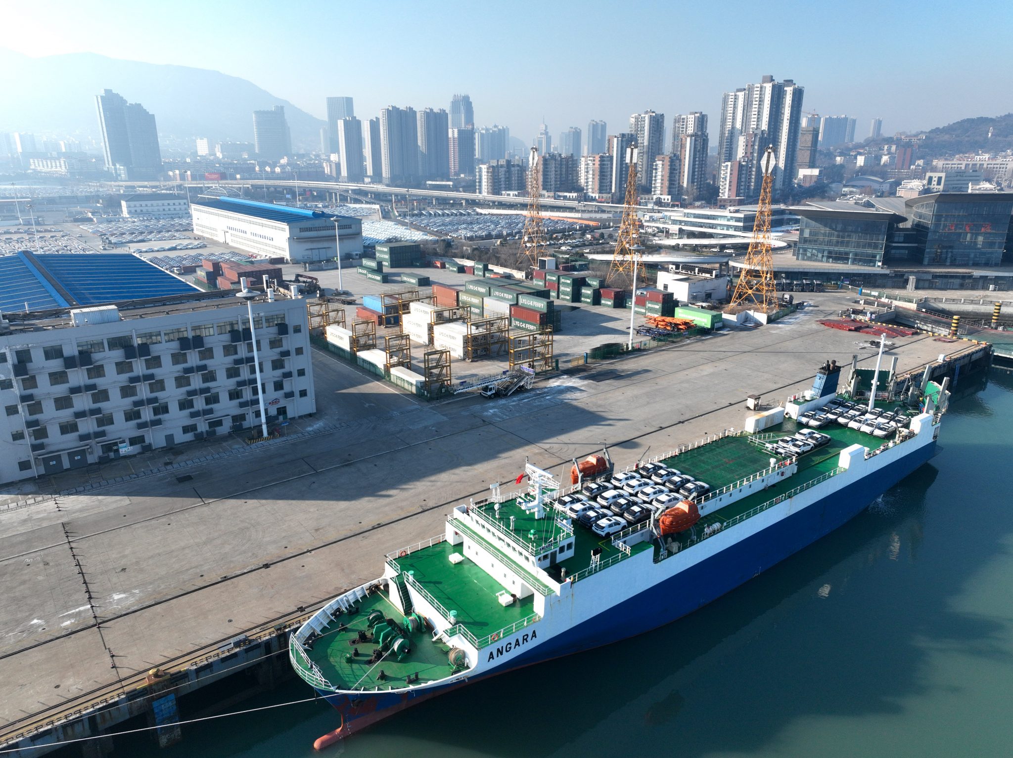 Roll-on wheels load cars for export at a dock in Lianyungang, China, 24 December 2023 (Photo: Reuters/CFOTO/Sipa USA).